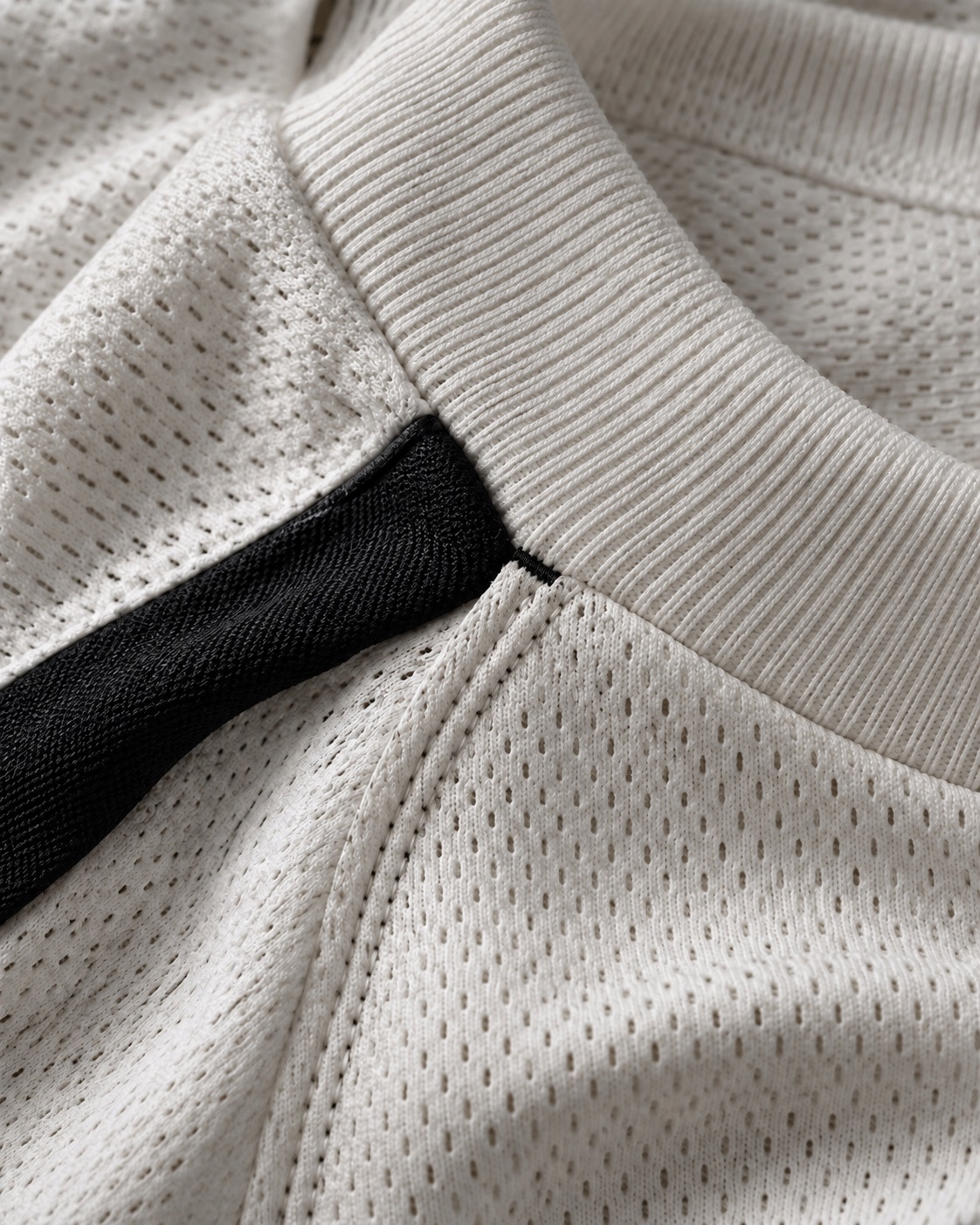 Illustrative close view of mesh and smooth knit sportswear structures